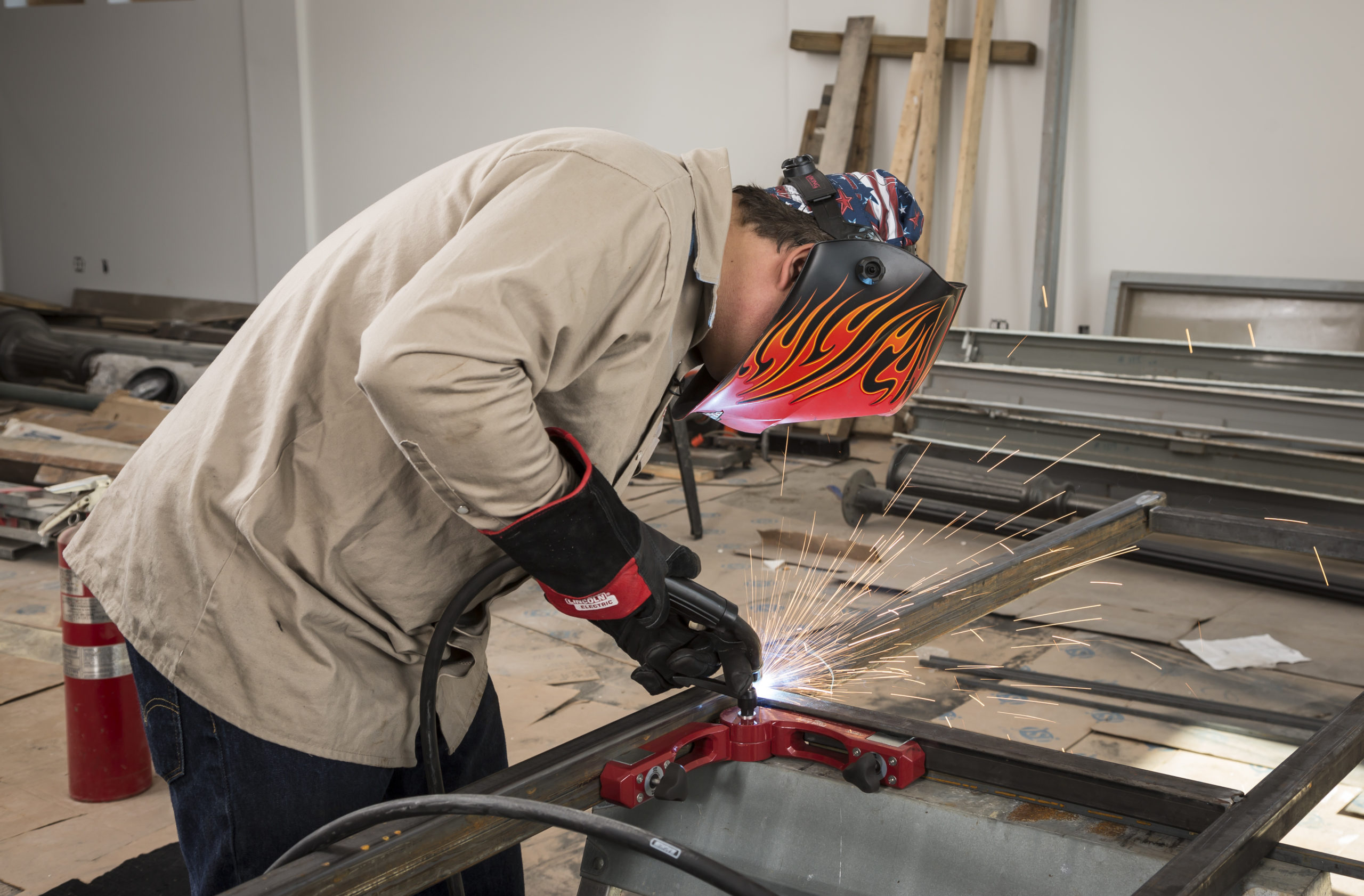 Tacking joints during fabrication of railing, Welder uses a Pivot Angle magnetic fixture during fabrication of a railing