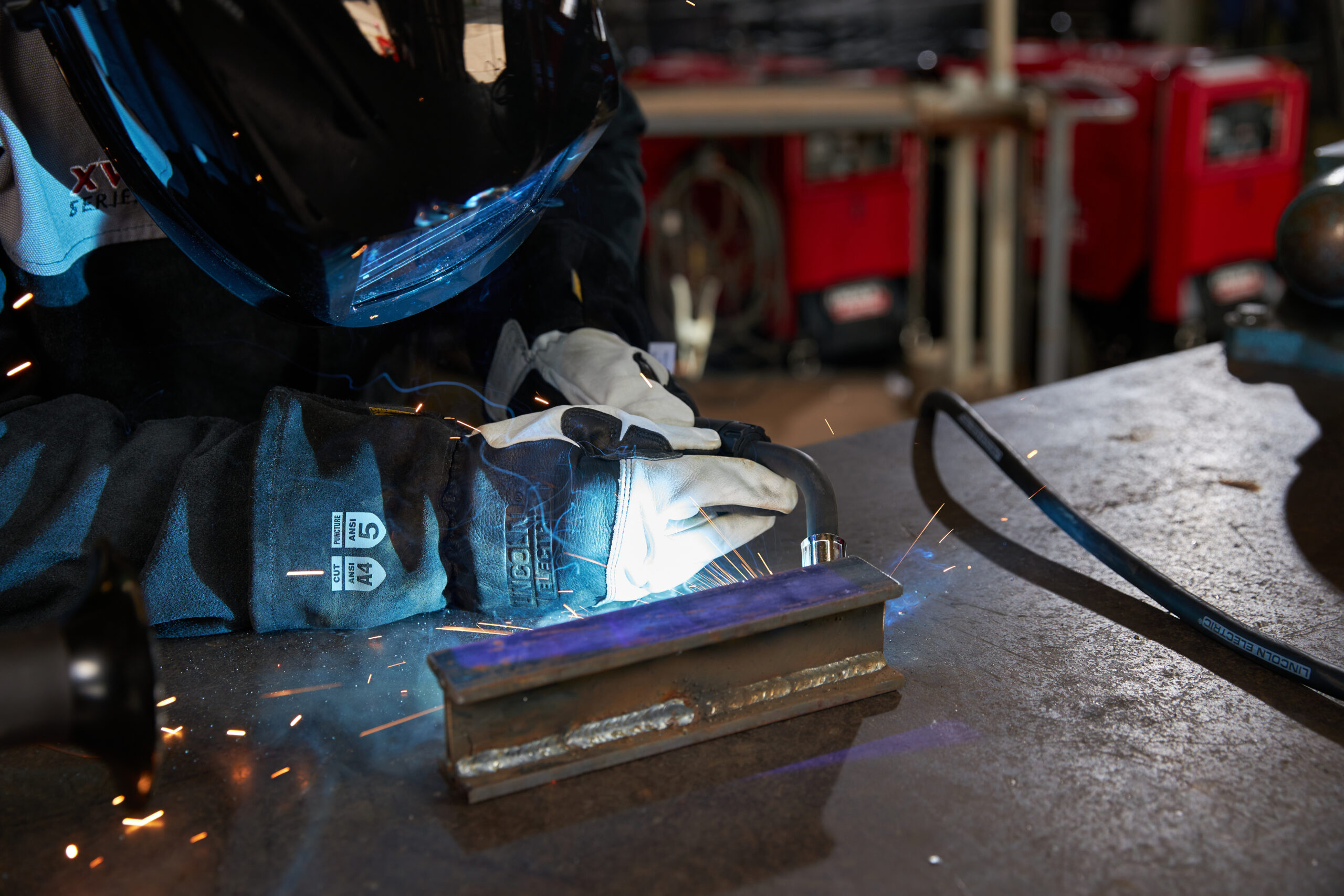 Welding professional using the Lincoln POWER MIG 211i welder