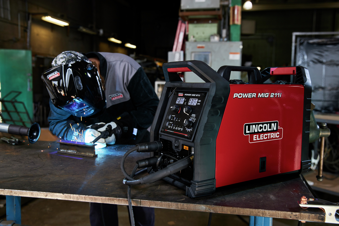 Welding professional using the Lincoln Electric Power MIG 211i.