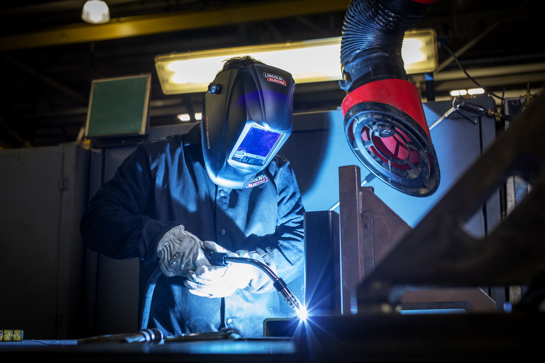 Welder using a power mig 215 MPI machine